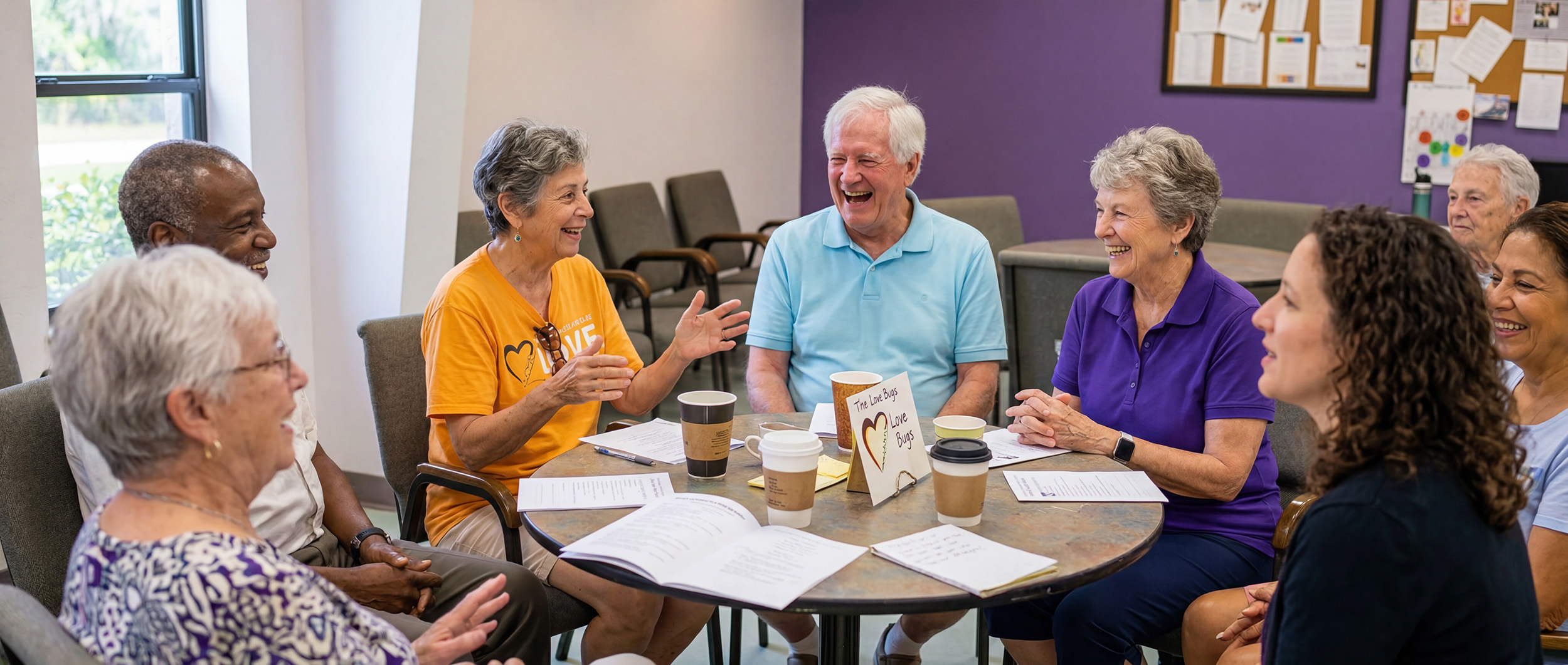 TriUU members gathered around a fellowship table sharing coffee, laughter, and lively conversation