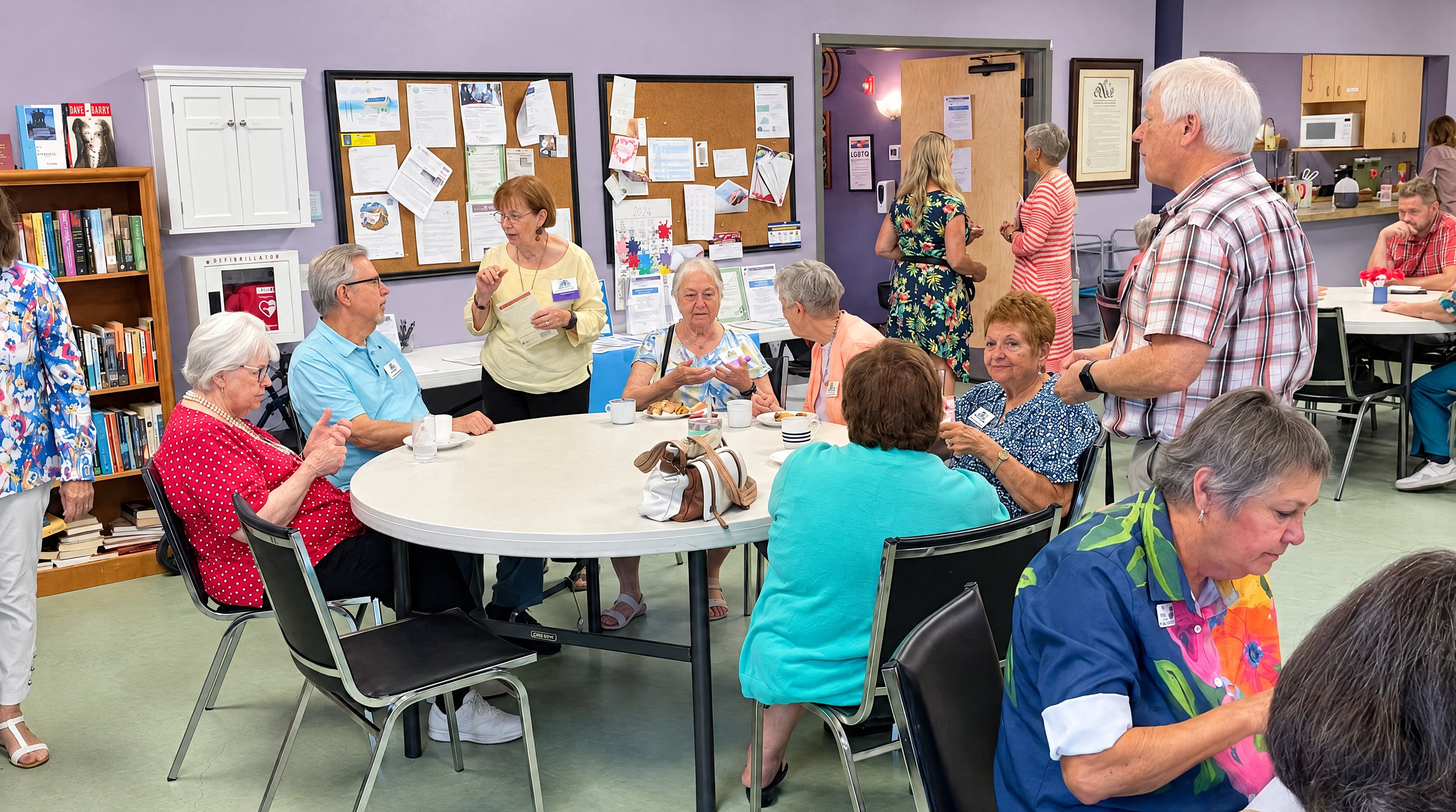 TriUU members talking over coffee at round tables during Sunday coffee hour